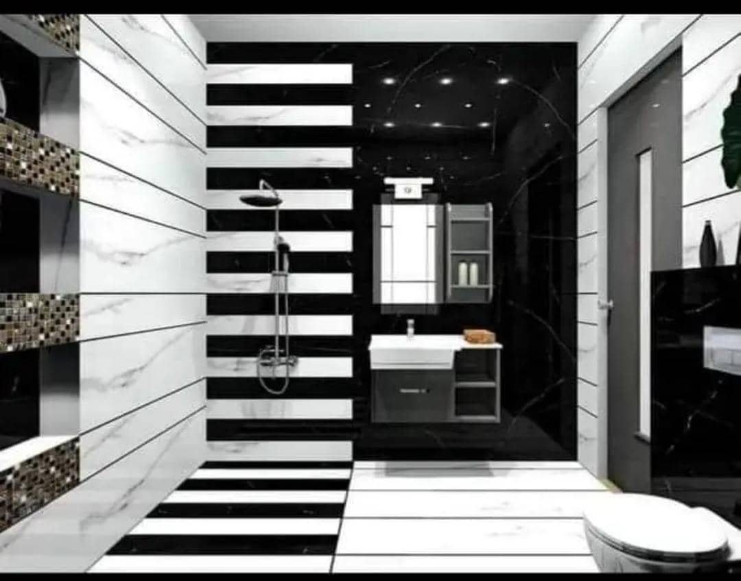 A black and white master bathroom tiled by Fabish House Finishings