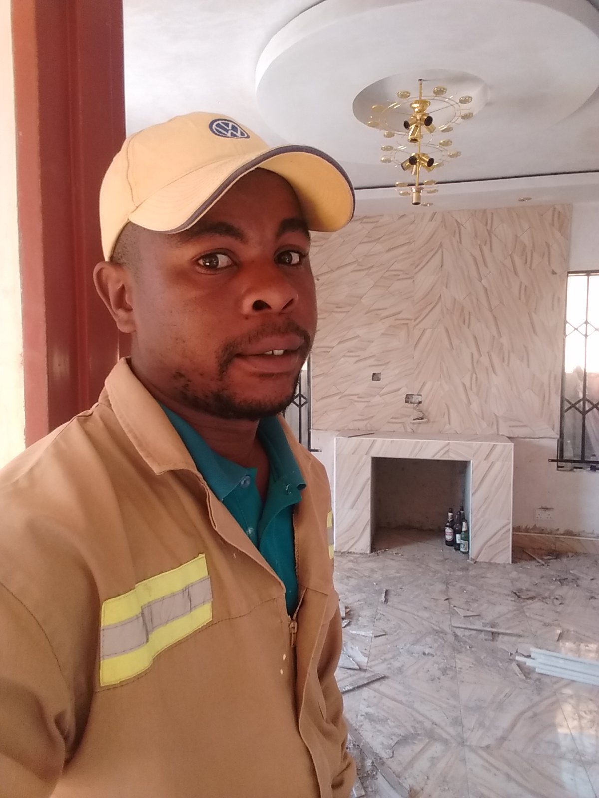 The founder of Fabish House Finishings on site in front of a finished feature wall and fireplace