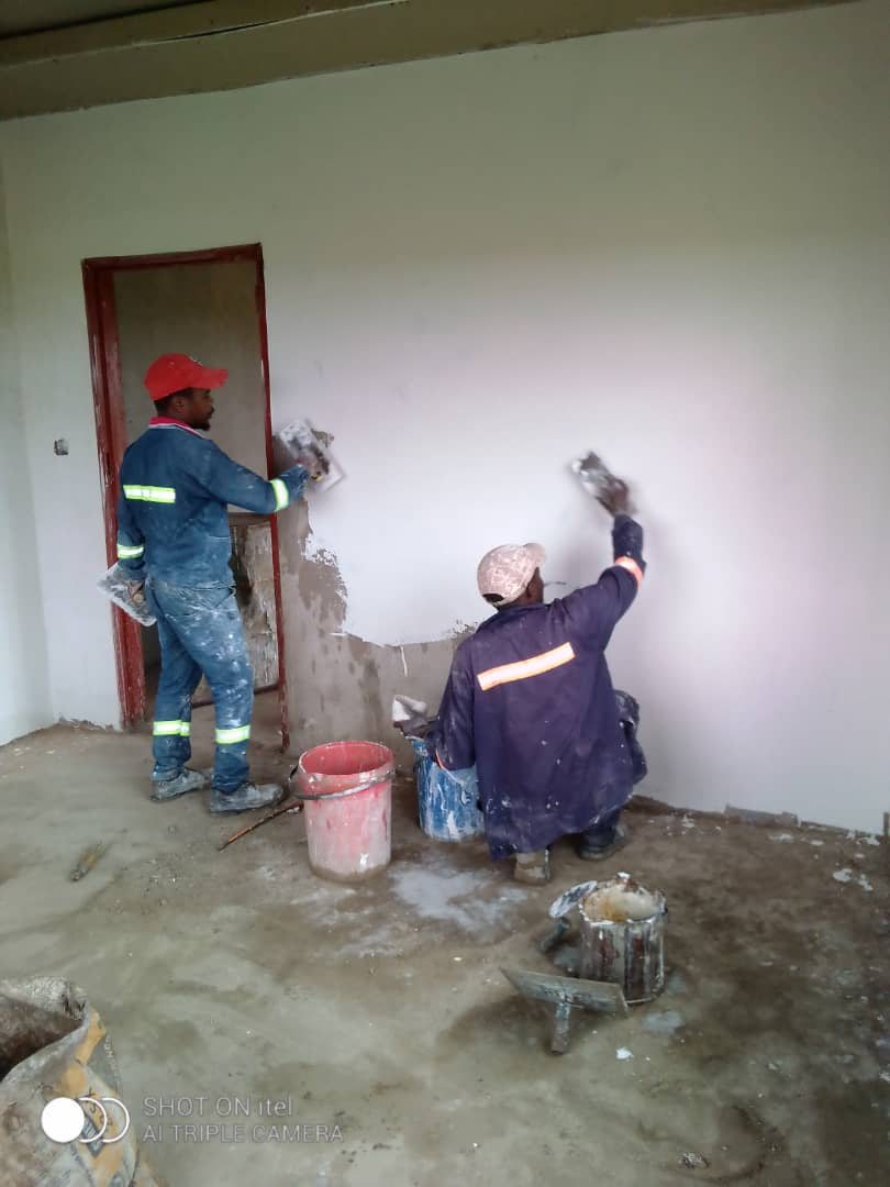 Two Fabish plasterers skimming an interior wall